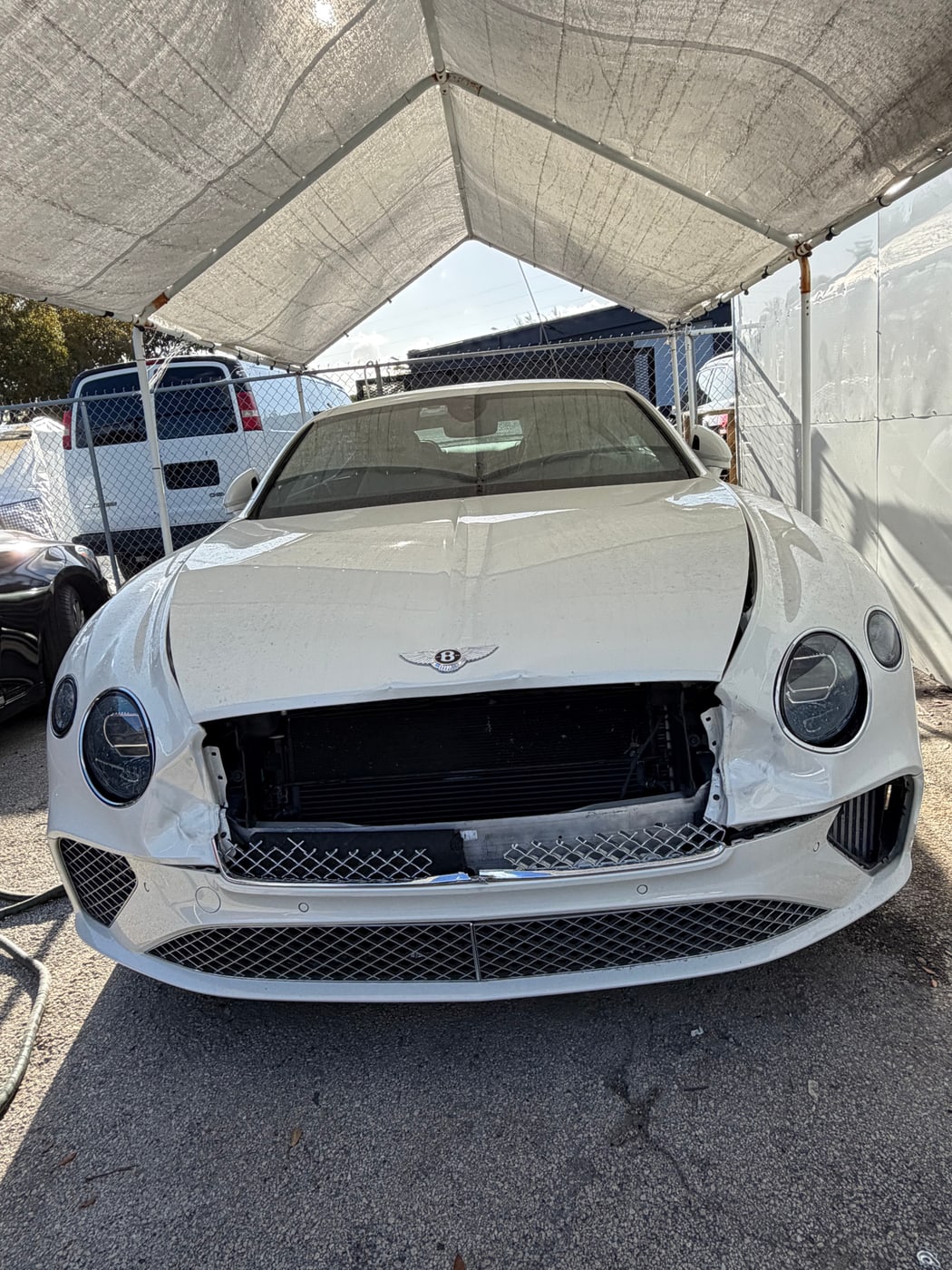 The same Bentley Continental GT before repair, showing front-end collision damage